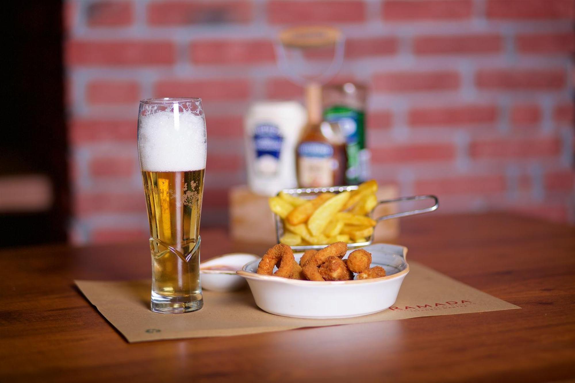 Ramada By Wyndham Istanbul Merter Luaran gambar A glass of beer with patatas fritas and croquetas